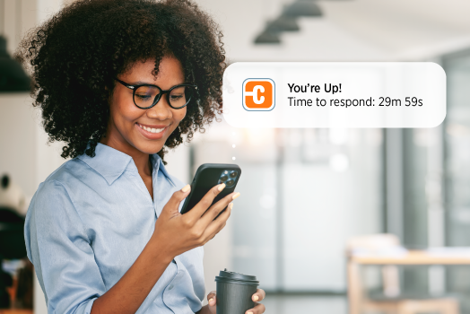 Person checking their phone to see waitlist notification from ChargePoint mobile app